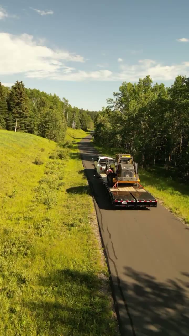 A flatbed load on a foothills road, from above